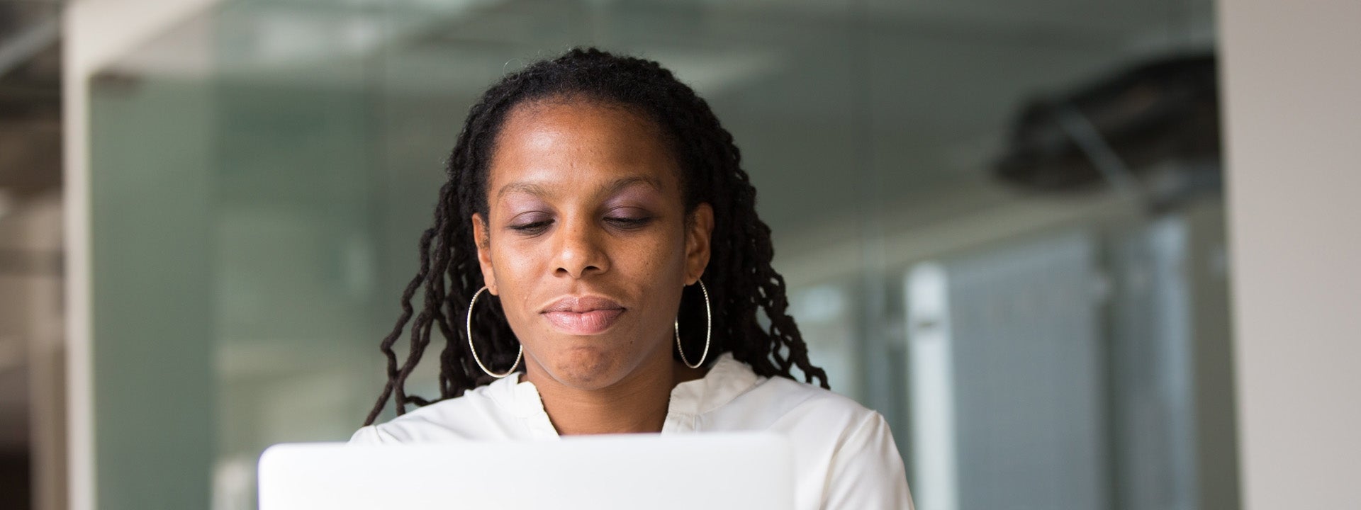 Woman typing at a laptop