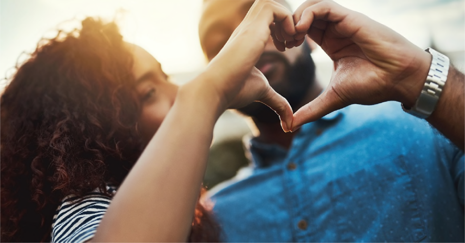 A couple making a heart with their hands