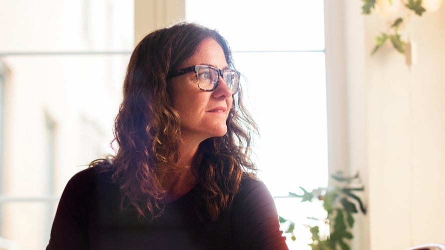 Woman with glasses looking into the distance