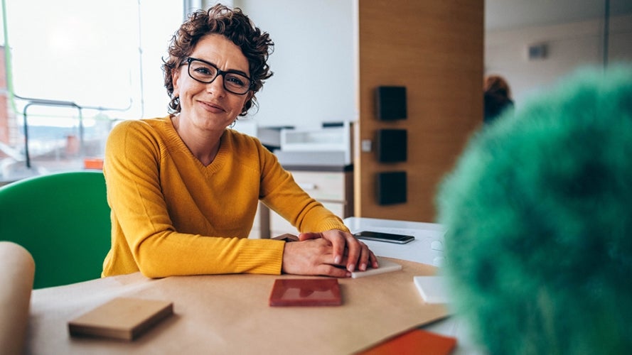 Woman wearing glasses at a table