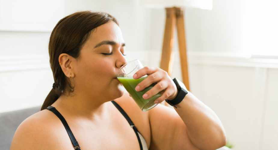 Person drinking green juice