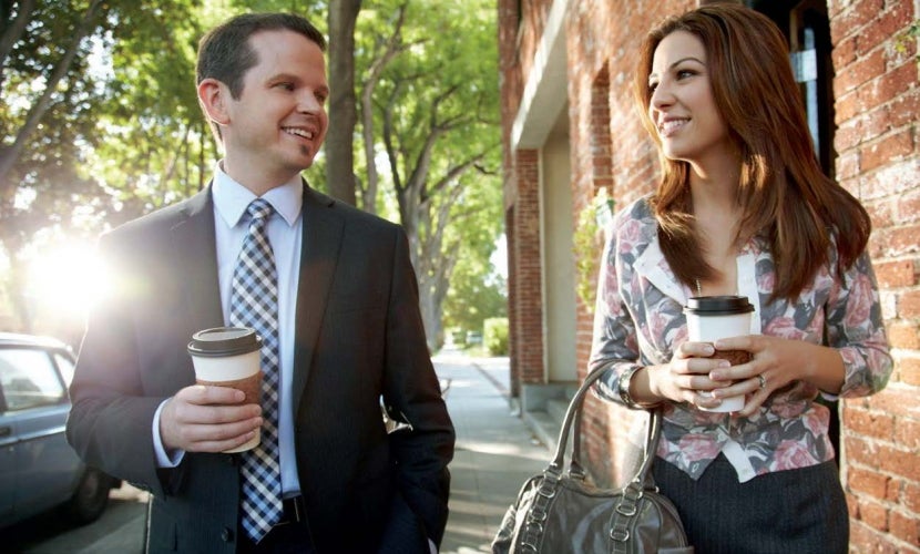 Two people strolling with coffee