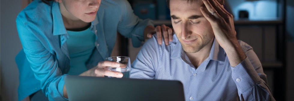 Person with a headache being offered medicine