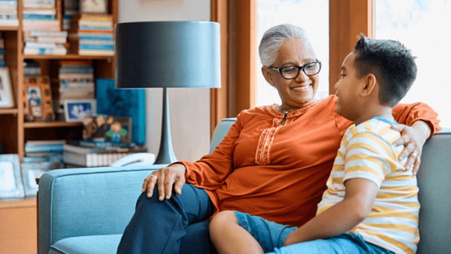 Woman and her child sitting on couch