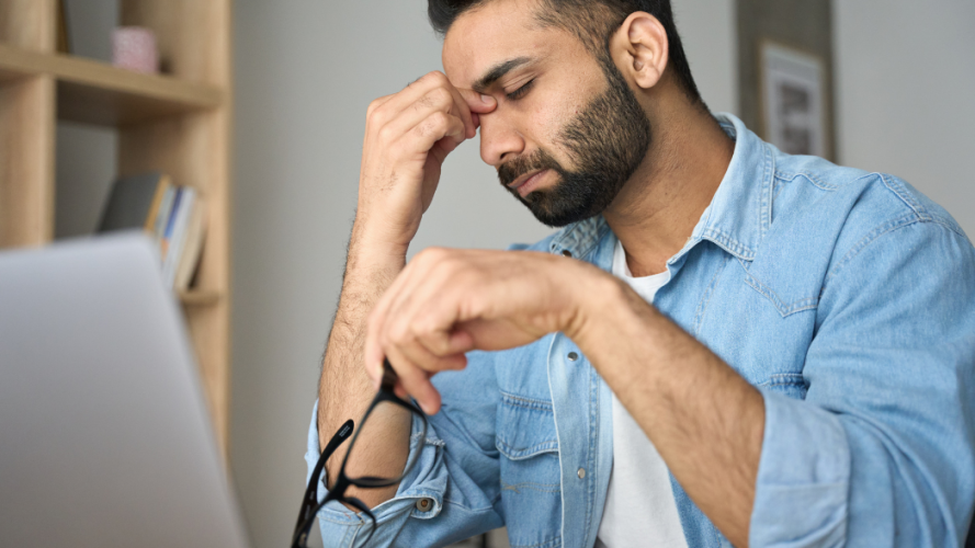 Person with tired eyes at a computer