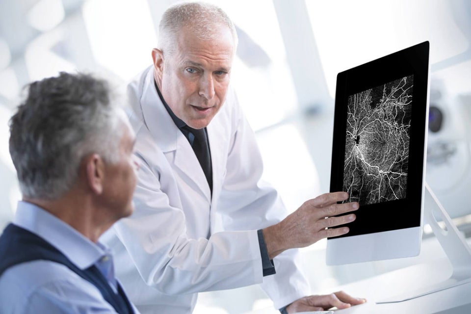 Eye doctor talking with patient