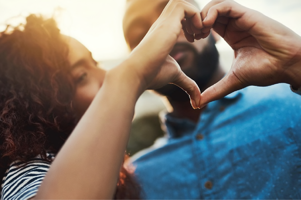 A couple making a heart with their hands