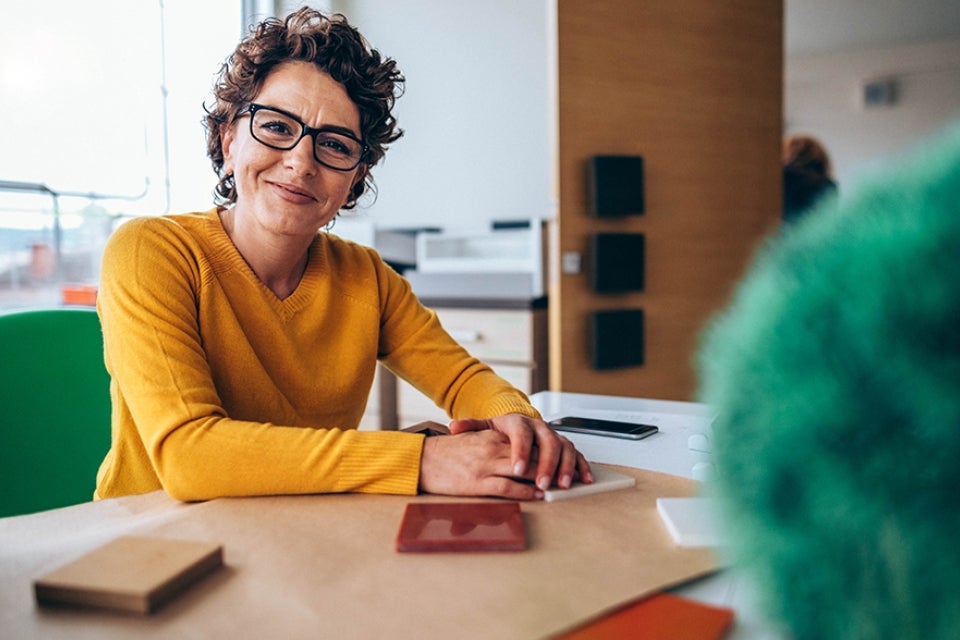 Woman wearing glasses at a table