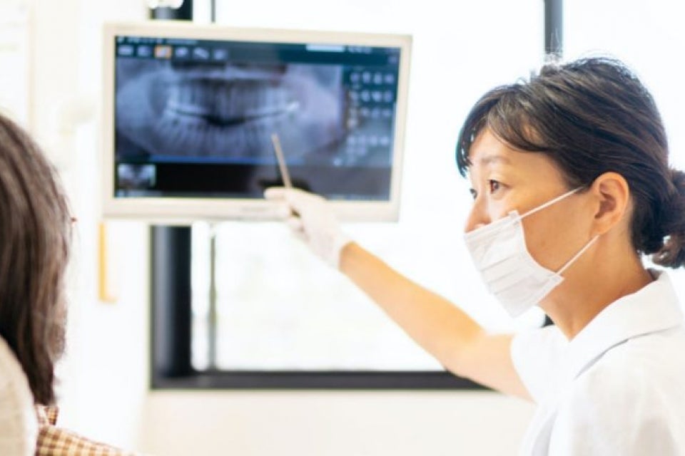 Dentist showing an xray to a patient