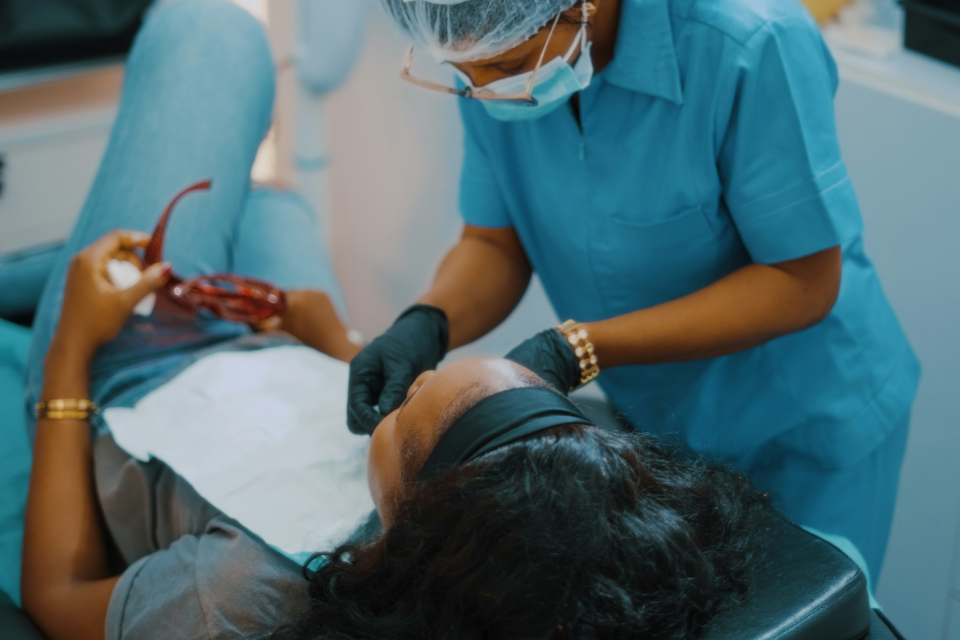 women in dentist chair getting an evaluation
