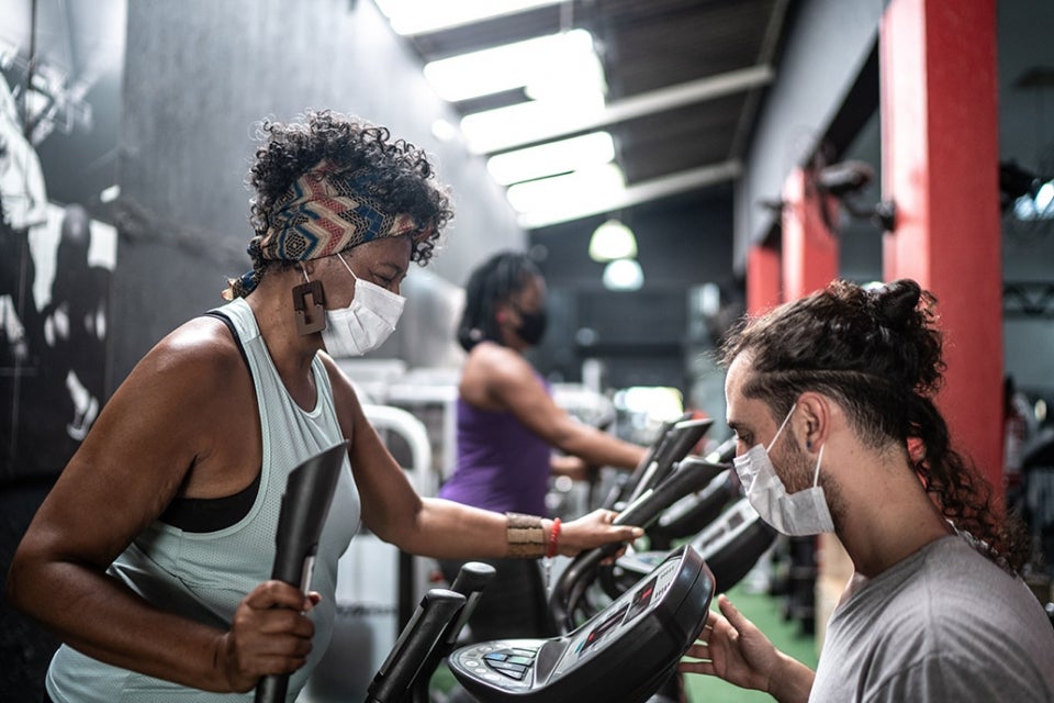 Woman working out in gym with mask