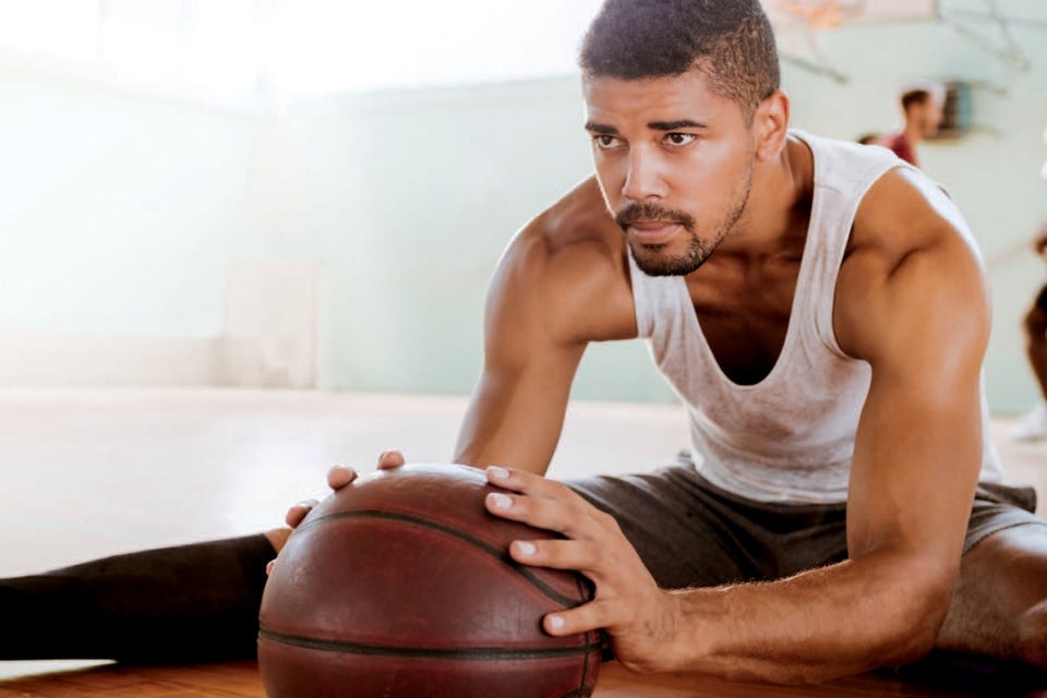 Person stretching with basketball
