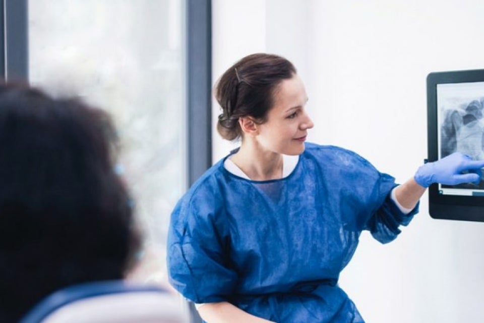 Dentist examining xray