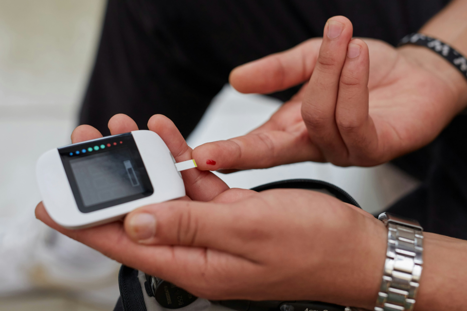 Person doing a finger-prick blood sugar test