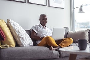 Person on couch working on laptop