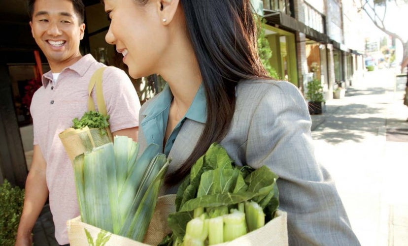 Couple caring groceries on street
